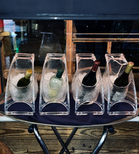 Load image into Gallery viewer, Four wine bottles in clear ice buckets on a metal tray with a dark background.